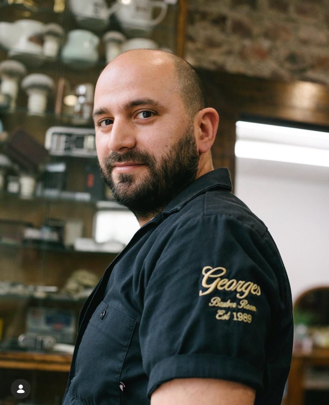 Mike, owner of George's Barber Room, in the shop on Kentish Town Road